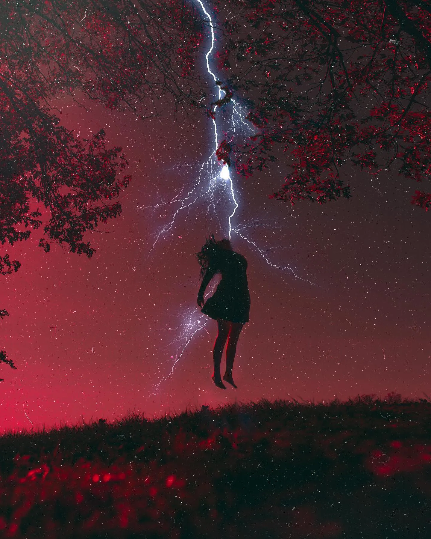 A magenta-pink sky with a dark figure suspended in the air beside a bolt of lightning.